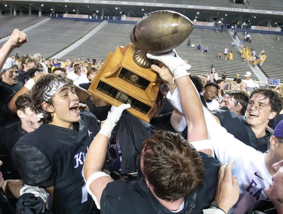 The Falcons celebrate their victory by proudly holding up the SJS game trophy  after an unforgettable season of hard work and dedication.